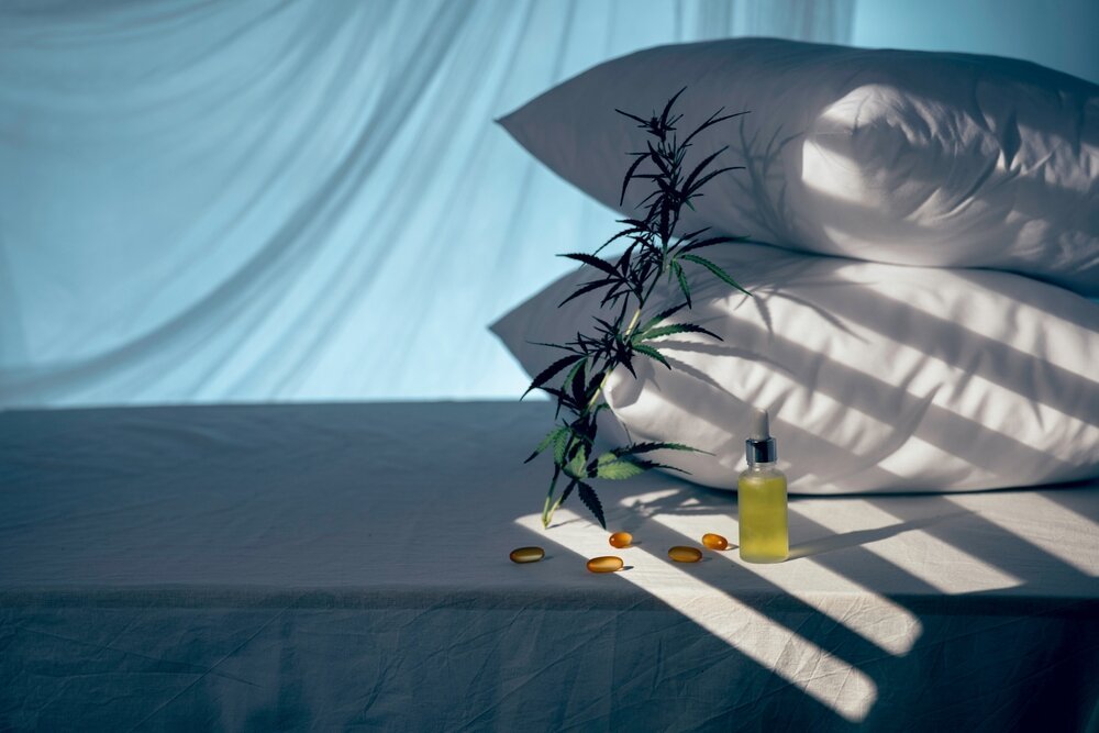 Cannabis and Sleep. Evening Bedroom With Cbd Oil Capsules And A Cannabis Branch.