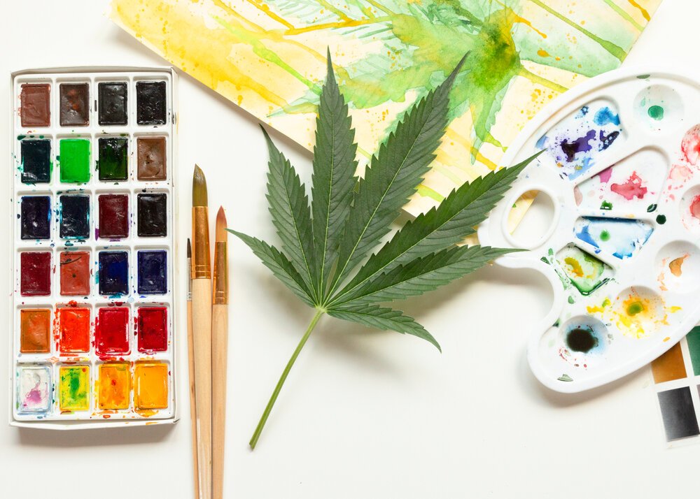 Cannabis and Creativity. Marijuana leaf with paints and paint brush.