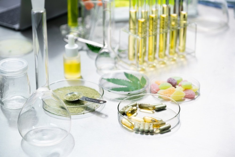 Lab Testing in the Cannabis. Selective focus Cannabis products including Powders, Oil, Infused gummy, Gel pills, and Cannabis Capsules on scientist table in the laboratory. Cannabis for medical concept.